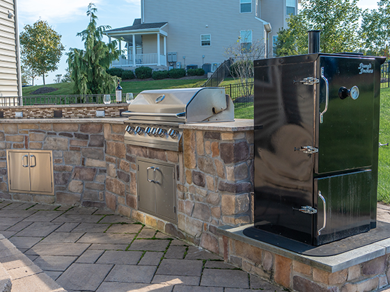 Outdoor patio installation with grill and smoker