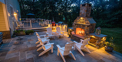 Hardscape installation featuring a paver patio and outdoor fireplace with seating