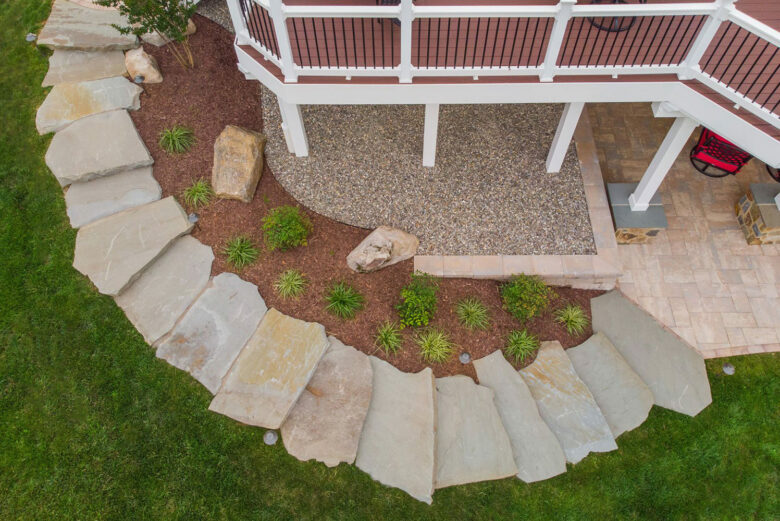 Natural stone hardscaping for a walkway connecting the patio