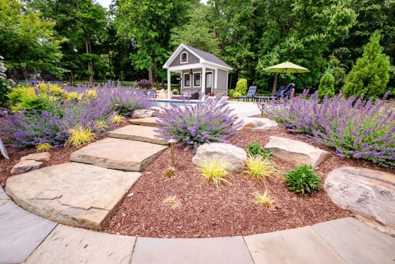 Natural stone hardscaping for a walkway connecting the patio to the pool area